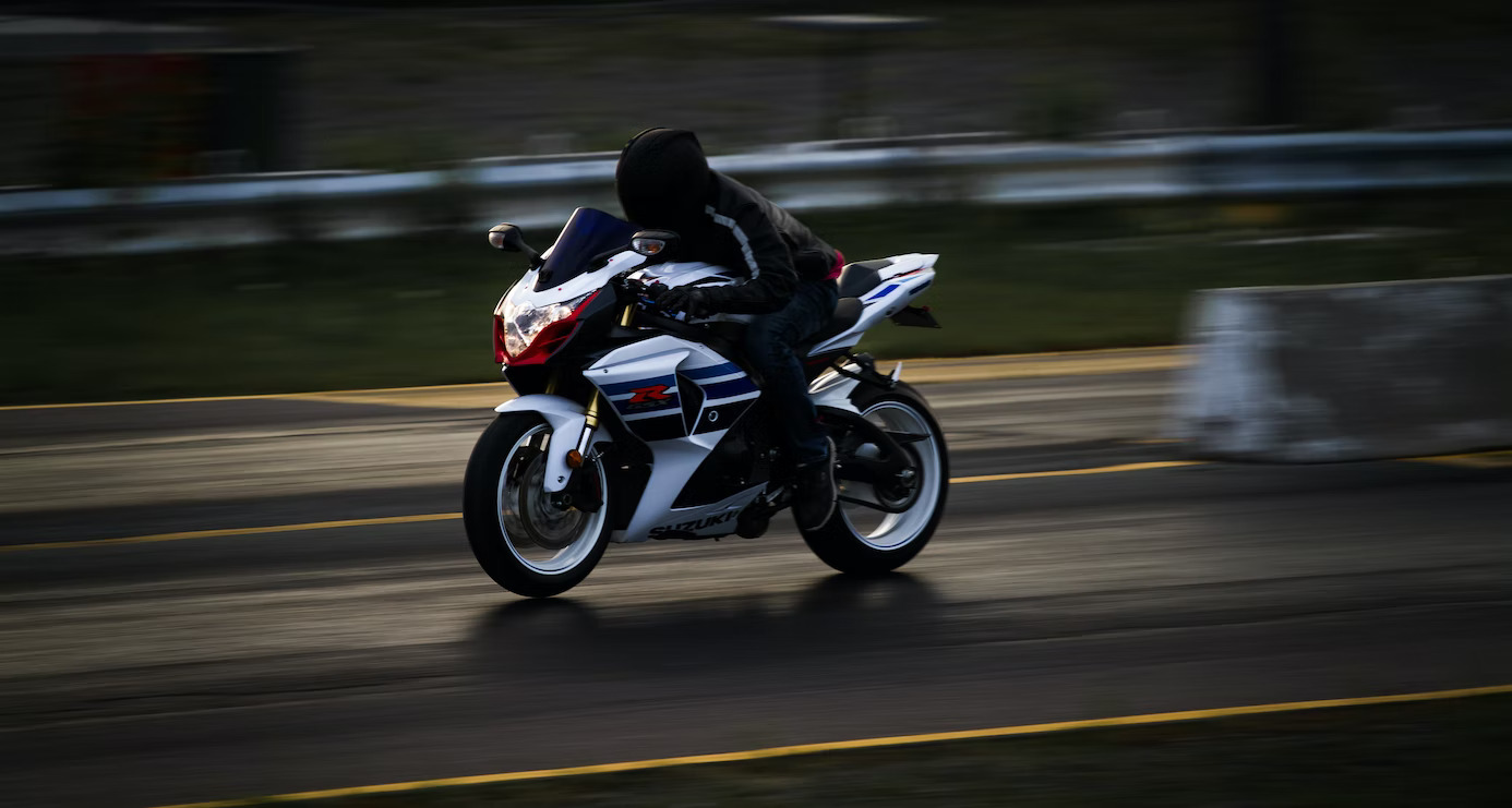 A person speeding on a motorcycle