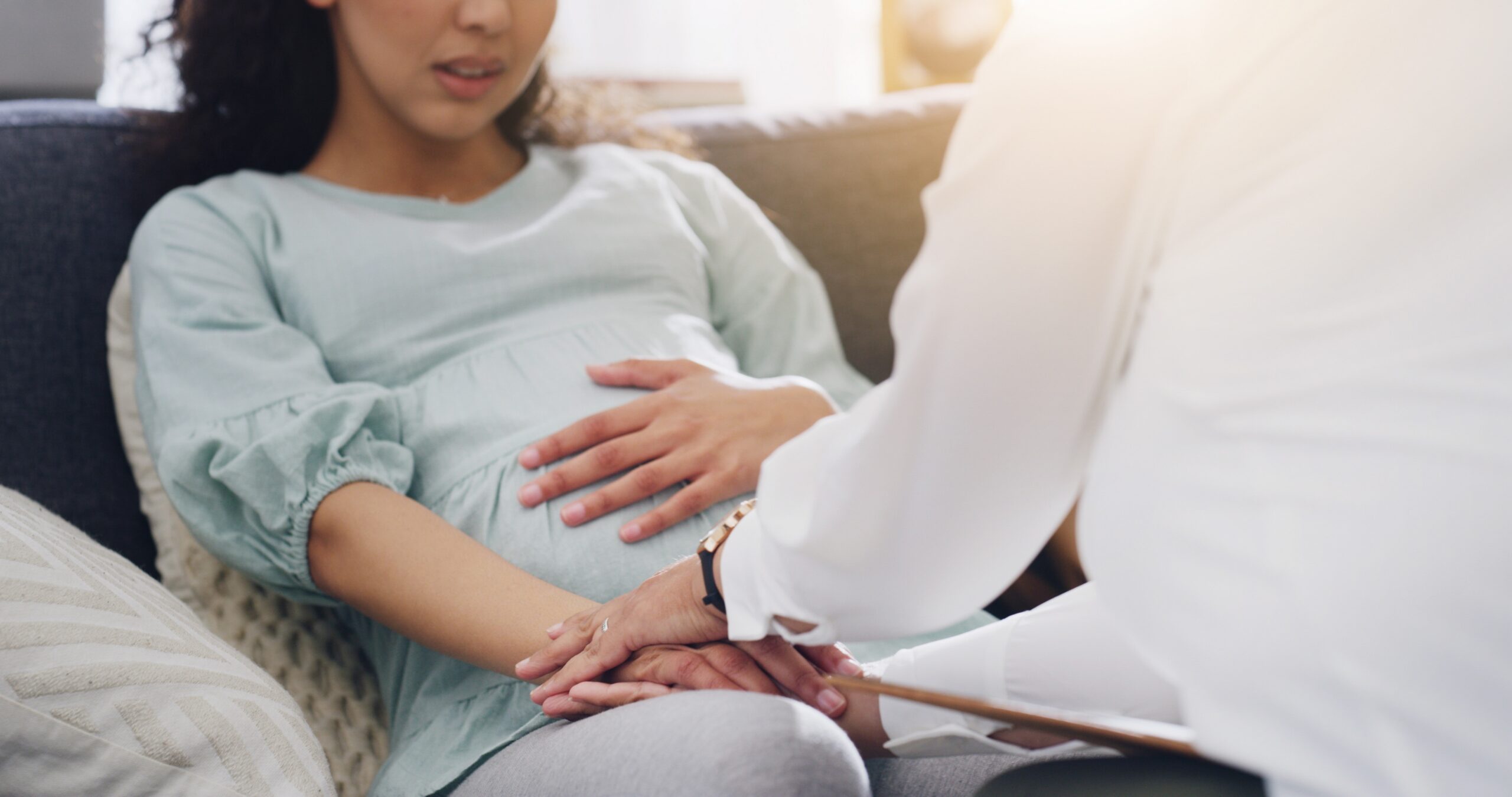 Pregnant woman consulting a doctor about symptoms that may require investigation for delayed diagnosis and medical negligence.